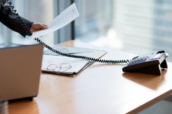 Desk with phone and laptop